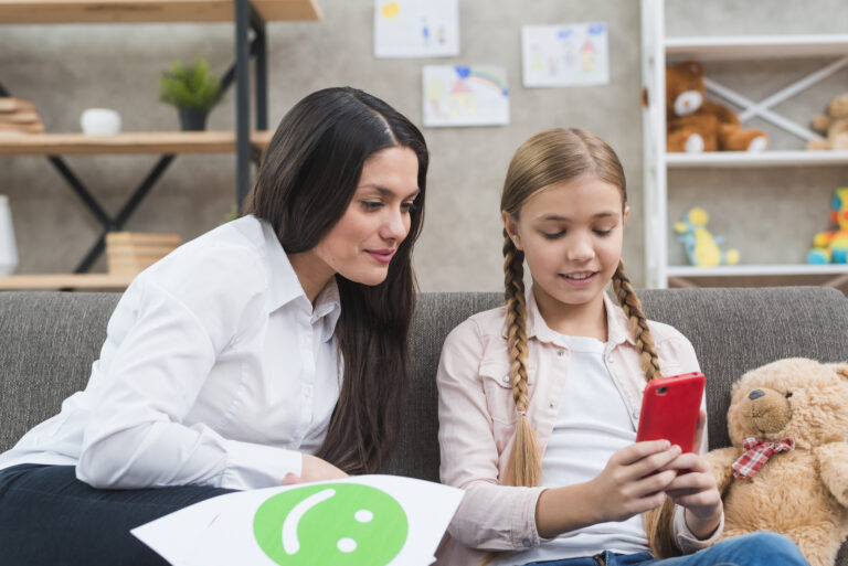young-child-psychologist-looking-mobile-phone-hold-by-little-girl